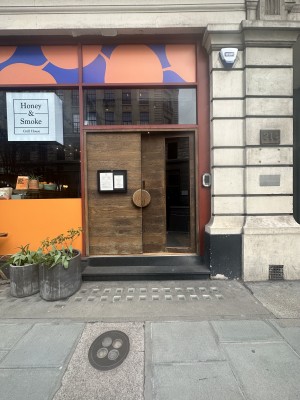 View of the main entrance. There are two steps to enter to the main area. There is a double door , one of them has glass. The handle is on the center.