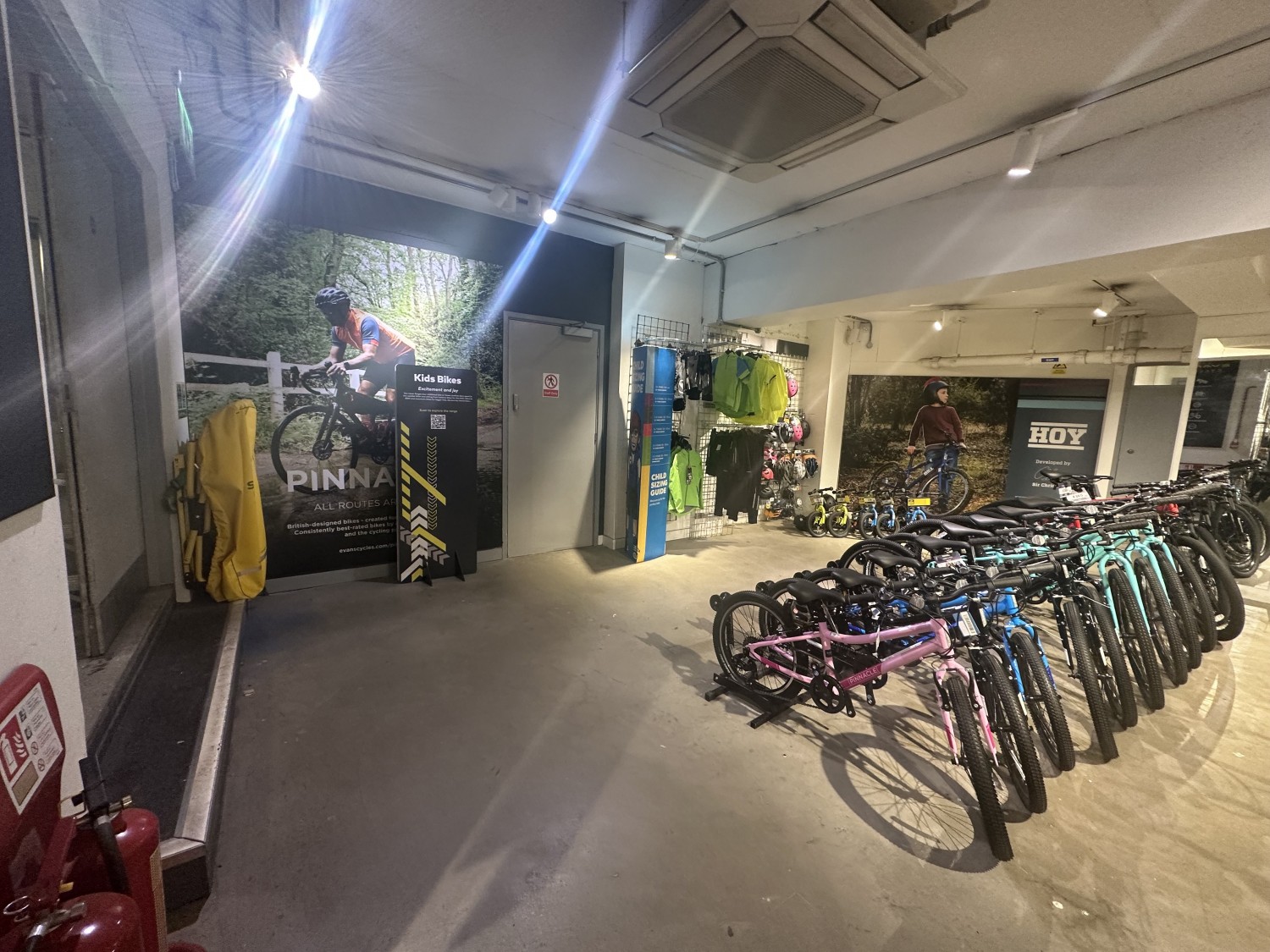 View from the downstairs area. After the ramp, turning left there is a side area with bikes on display on the center of the space. On the right corner there is a shelve with bike products.