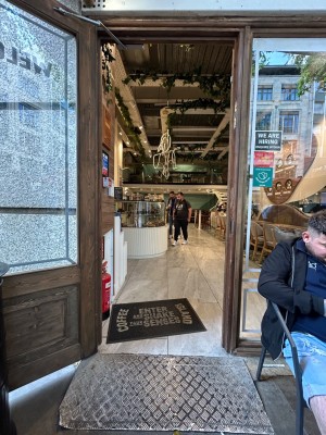 Single brown wooden door with large glass panel. Pull from right to open.