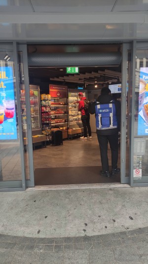 Automatic glass door with grey frames ahead.