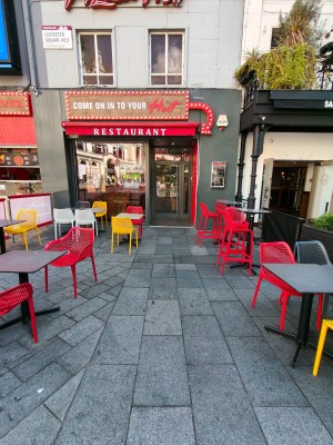 Facing venue. Path in centre to entrance at back. Takeaway counter at far left.
