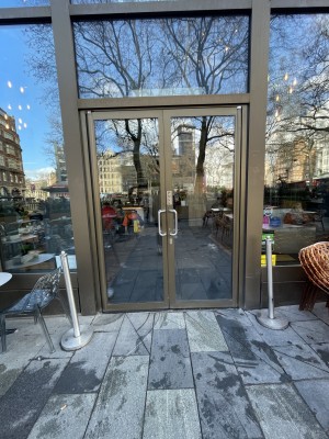 Double pull doors. Handles are in the centre of the doors at centre height for both doors. Pull the right door from the left and the left door from the right.