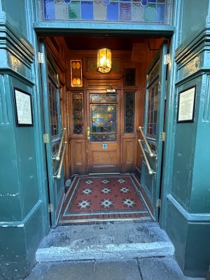 Preceding double green doors with glass panels. Push from middle to open.