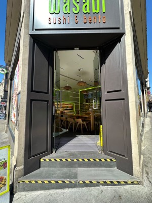 Glass doors with silver vertical handles in centre. Push to open.