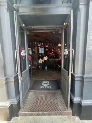 Black framed glass doors. Pull open via handles in centre.