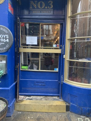 Entrance to left of venue, push to open by long horizontal bar across the door high up on door. Step before door.
