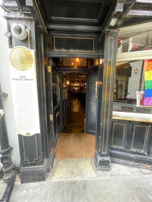 Wooden door with glass panel, handle at right. Push to open.