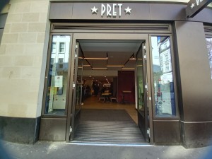 Glass doors with brown frames ahead. Vertical push door handles located in centre.