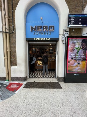 Open entrance ahead. White columns on left and right.