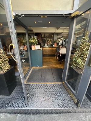 Grey framed glass doors. Pull open from centre.