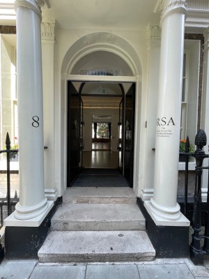 White archway at entrance. Pillars on either side.
