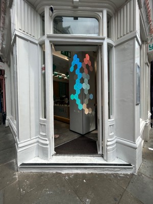 Double wooden doors with glass panels. Push from middle to open.