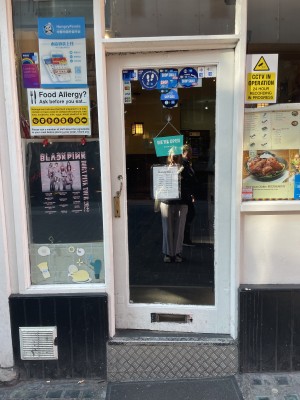 View of the main entrance to the venue. This is situated to the centre of the venue front. There is a door here that pushes open from the left. There is a large step at the foot of the door.