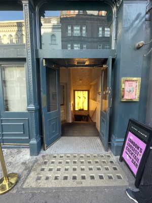 View of the main entrance to venue, located on the street. There are a set of double doors which pull open from the middle.