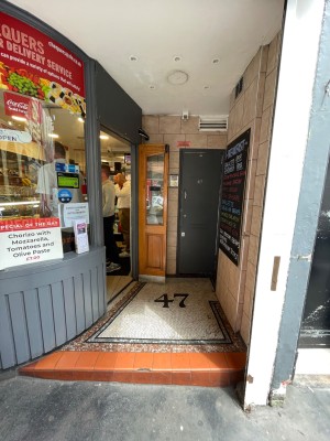 Archway to entrance to venue. Door at left.