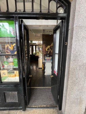 Black framed glass doors ahead. Push open from gold handles in centre.