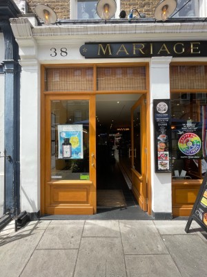 Wooden double doors with glass panels, handle in centre. Push to open.