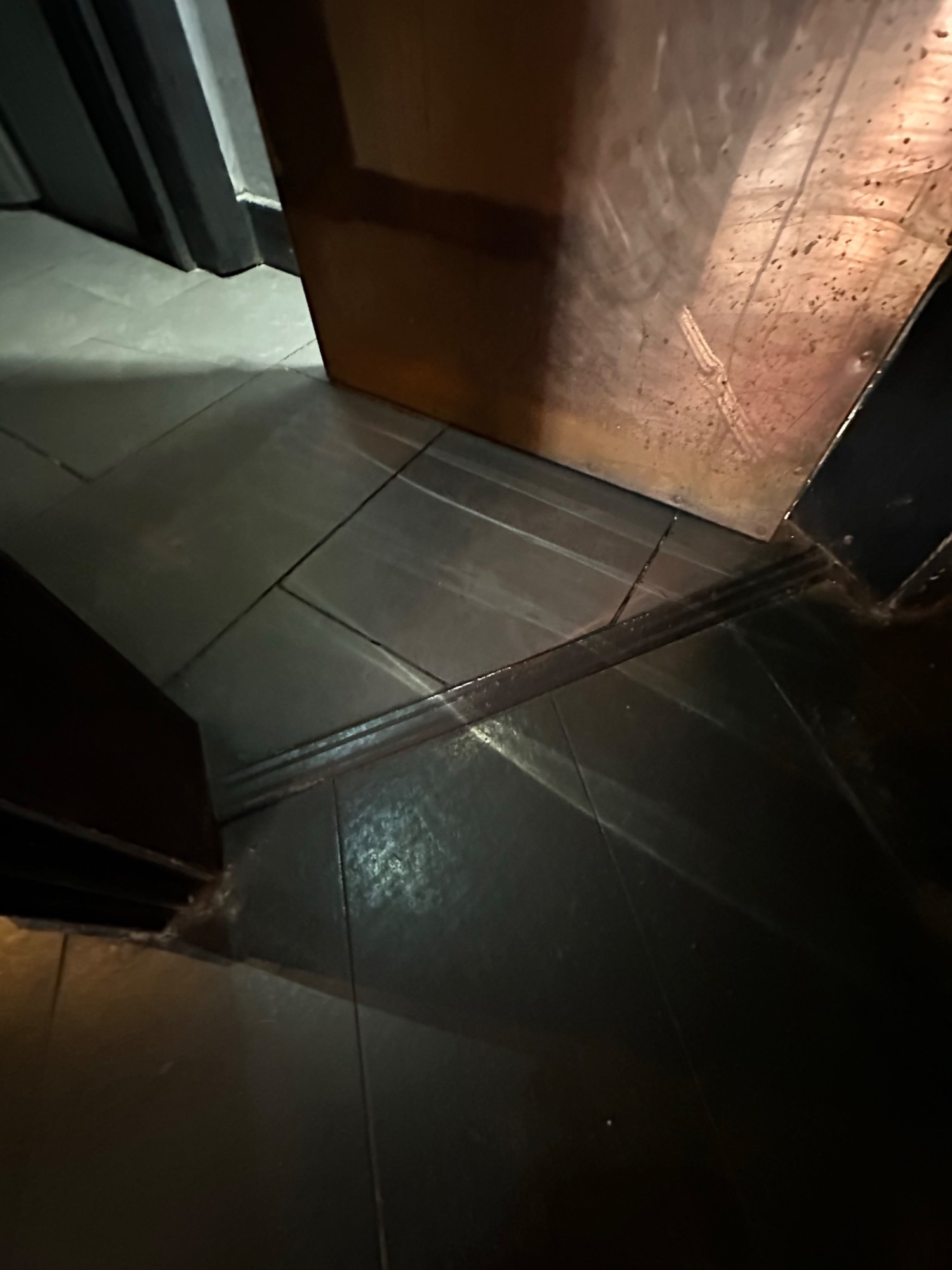 Small bump at foot of bathroom door.