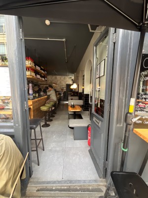 Grey framed doors with glass panels. Push open via handles in centre.