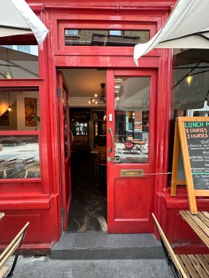 Red and glass panelled doors. Gold handles in centre of doors, push to open.
