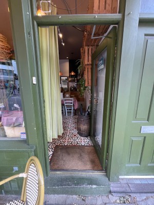 Green framed glass door. Push from left side to open.