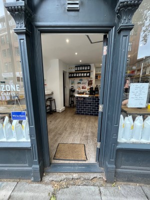 Grey framed glass door. Push open from left side.