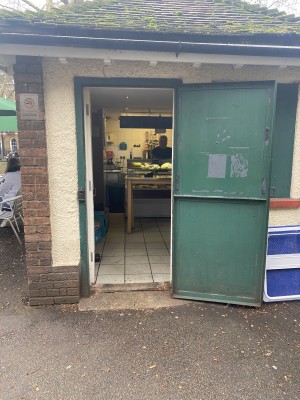 Green metal door. Pull green handle from left.