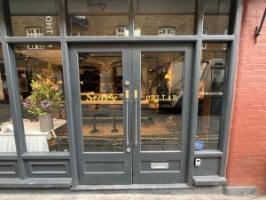 Grey framed glass doors. Push open via handles in centre.