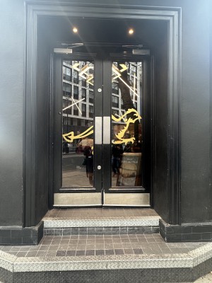 Main entrance. Doors need to be pushed to enter. Two steps before entrance.