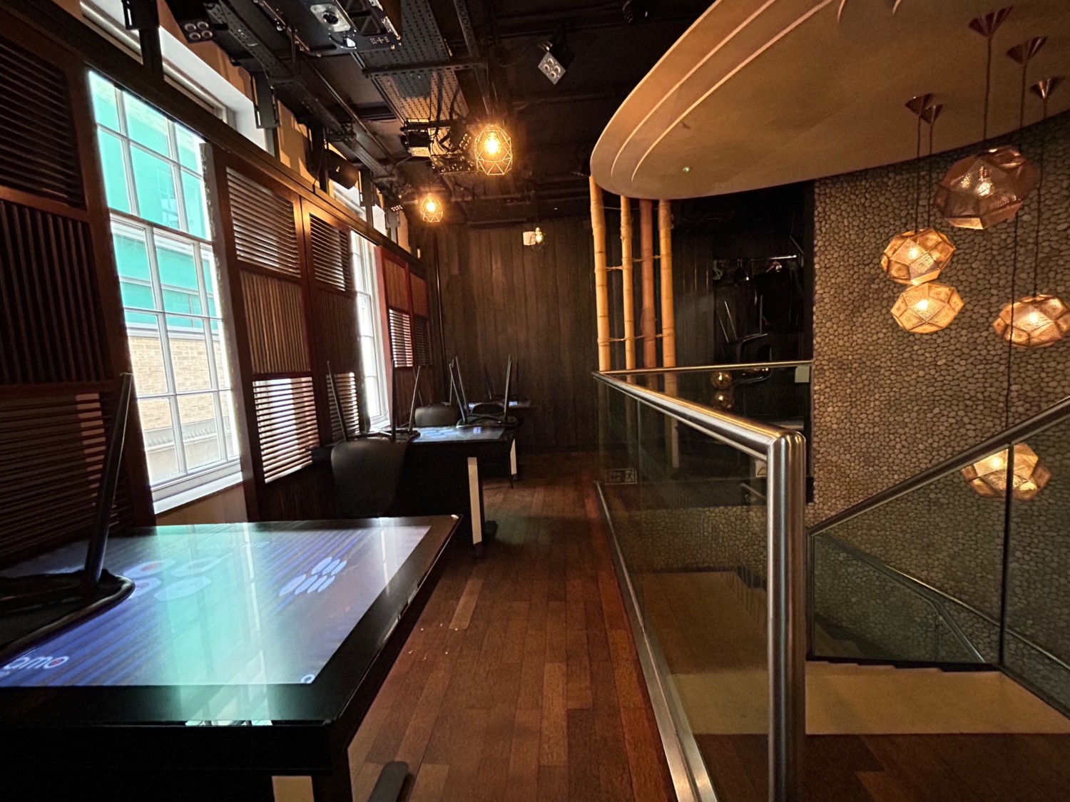 From right of stairs, looking back. Tables and chairs along left. Stairs on right. Path in middle.