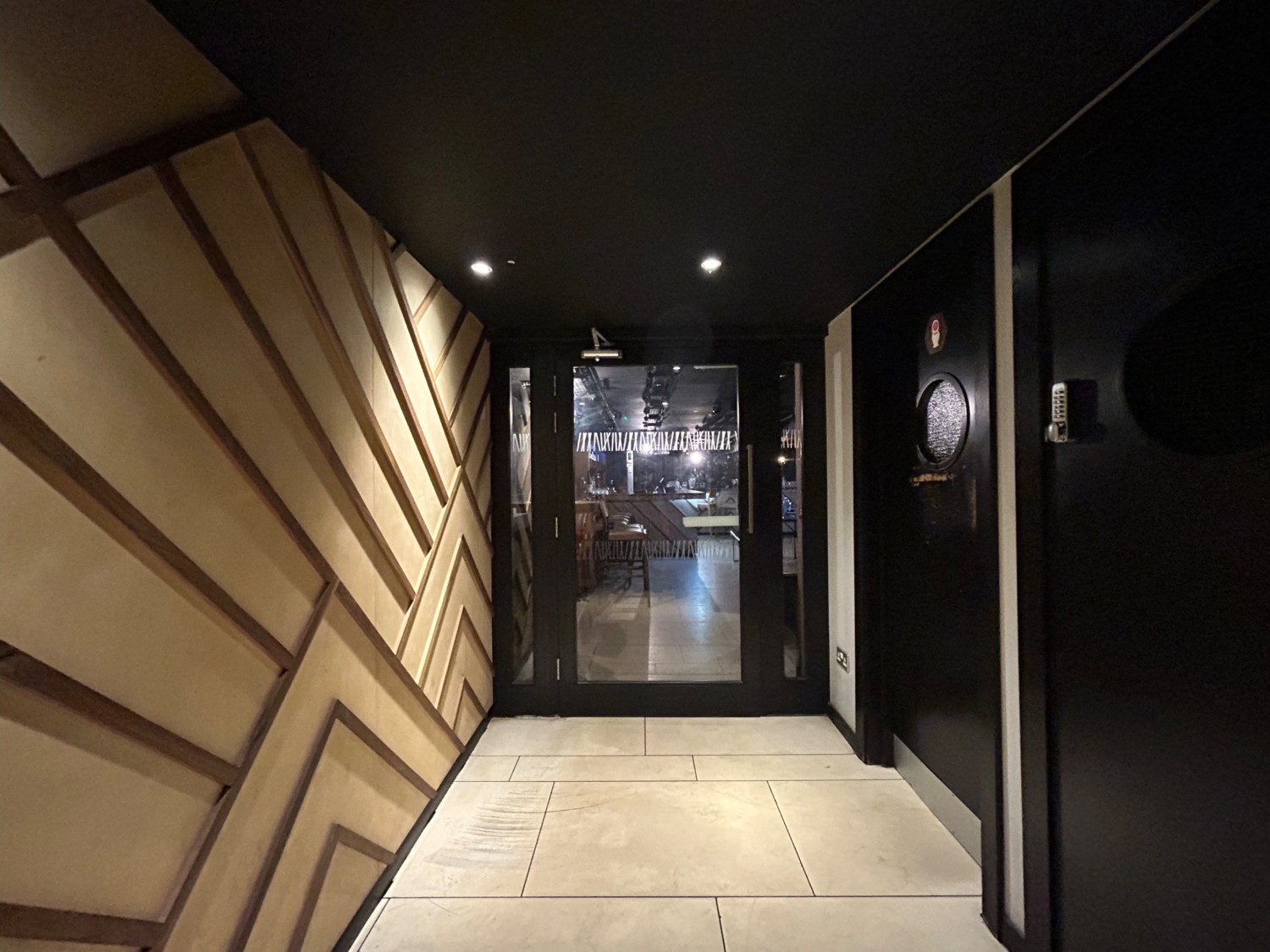 From bottom of stairs, facing right. Path ahead leads to toilets on right, and downstairs seating on back wall.