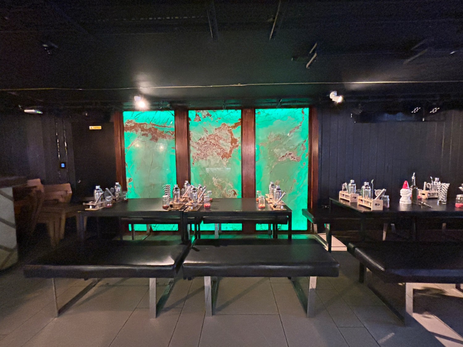 From middle of benches, facing right. Tables and benches along back wall.