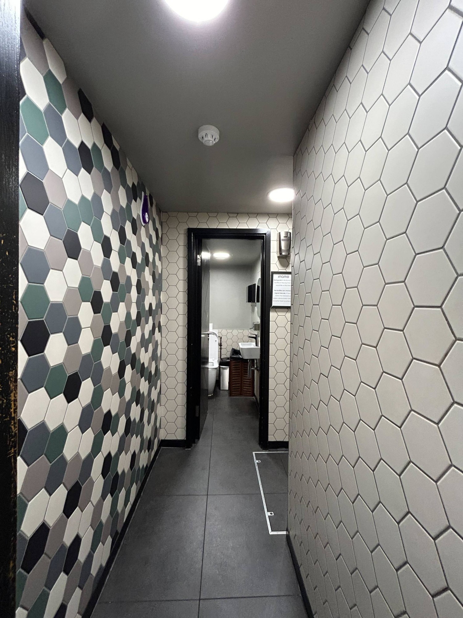From doorway, looking straight. Path ahead to cubicle door.