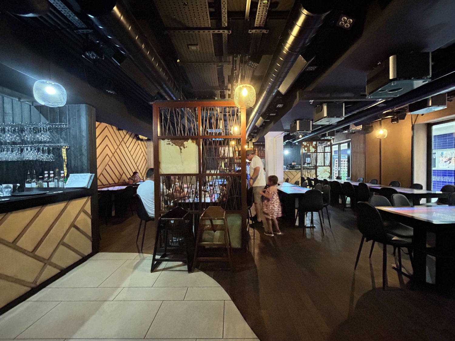 From pillar, looking right. Bar along left. Wooden partition ahead. Seating beyond and on right.