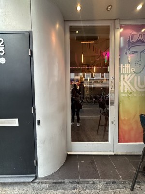 Entrance to the left of venue. Step before landing area before door.  Door pushes to open on right side.