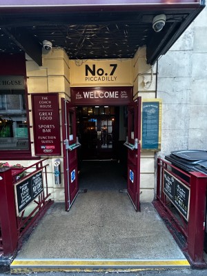 Red wooden double door. Pull to open. Silver handles on the middle.