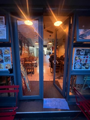 Glass doors with grey wooden frame. Turn silver handle on right door and push from middle.