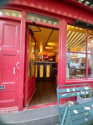 Entrance to the left of the venue from the street. Manual door push open from the right. There is a large step at the foot of the door.