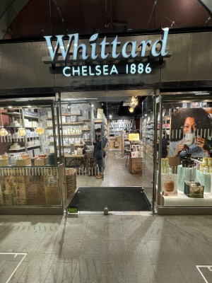 The main entrance is located at the centre of the shop front. There are glass double doors which push open from the centre. At the foot of the doors is a small bump.