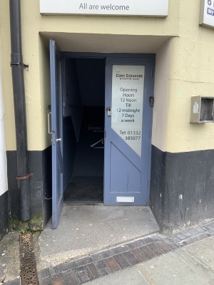 Doors dip back from front wall and pull to open by small high handles where the doors meet.