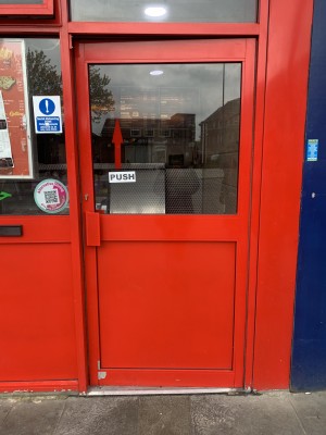 Door on right, push from left to open. Counter ahead.