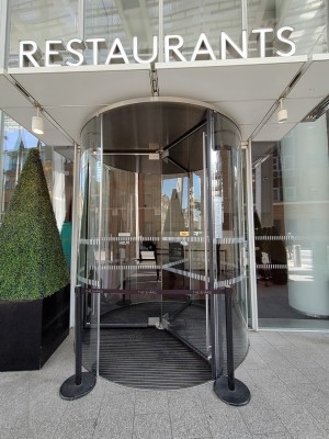 Automatic revolving doors to enter the building.