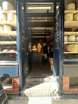 Double glass door, with blue wooden doorframe. Push at centre to open.