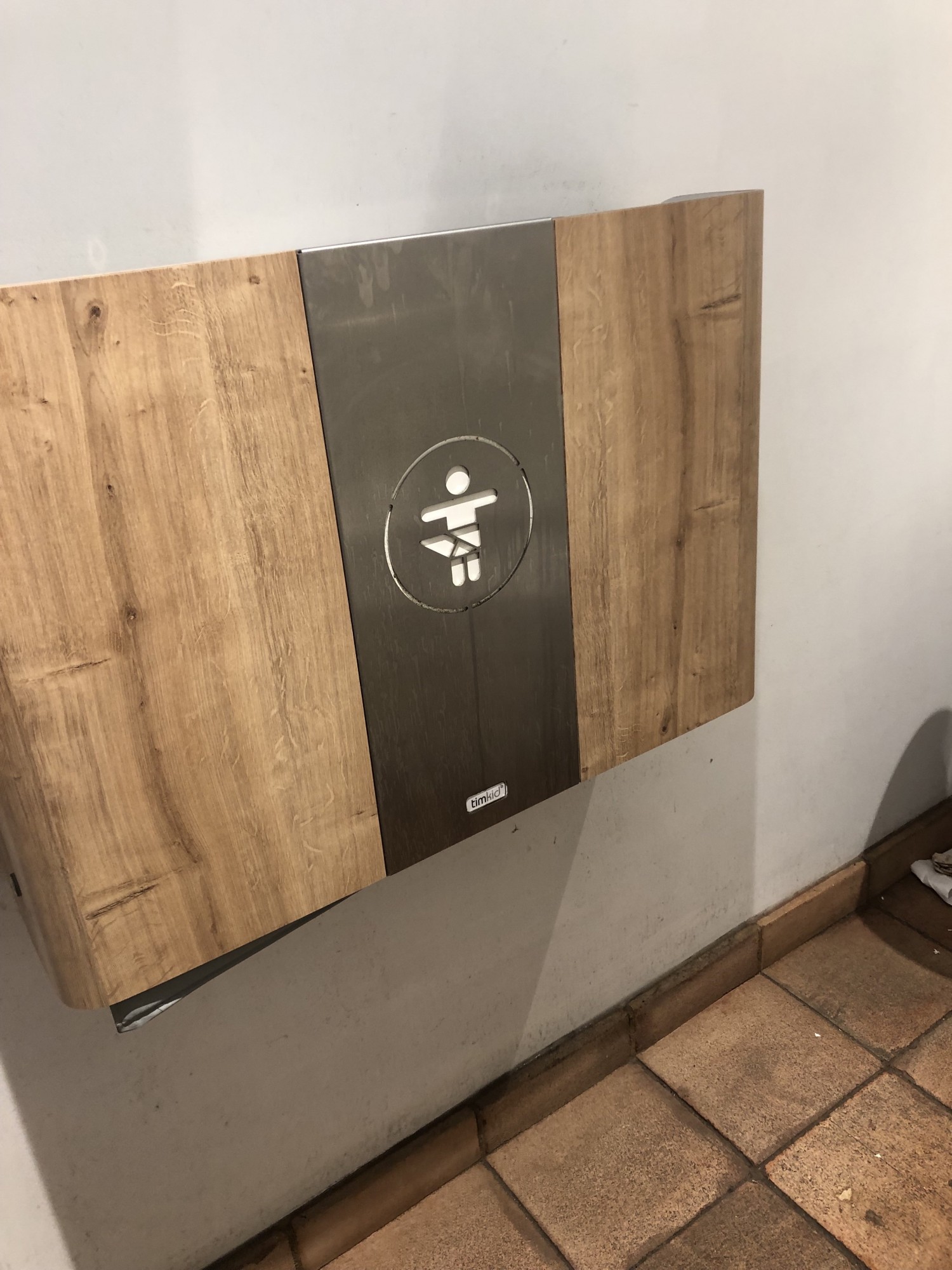 Wood veneer, fold down baby changing table on wall