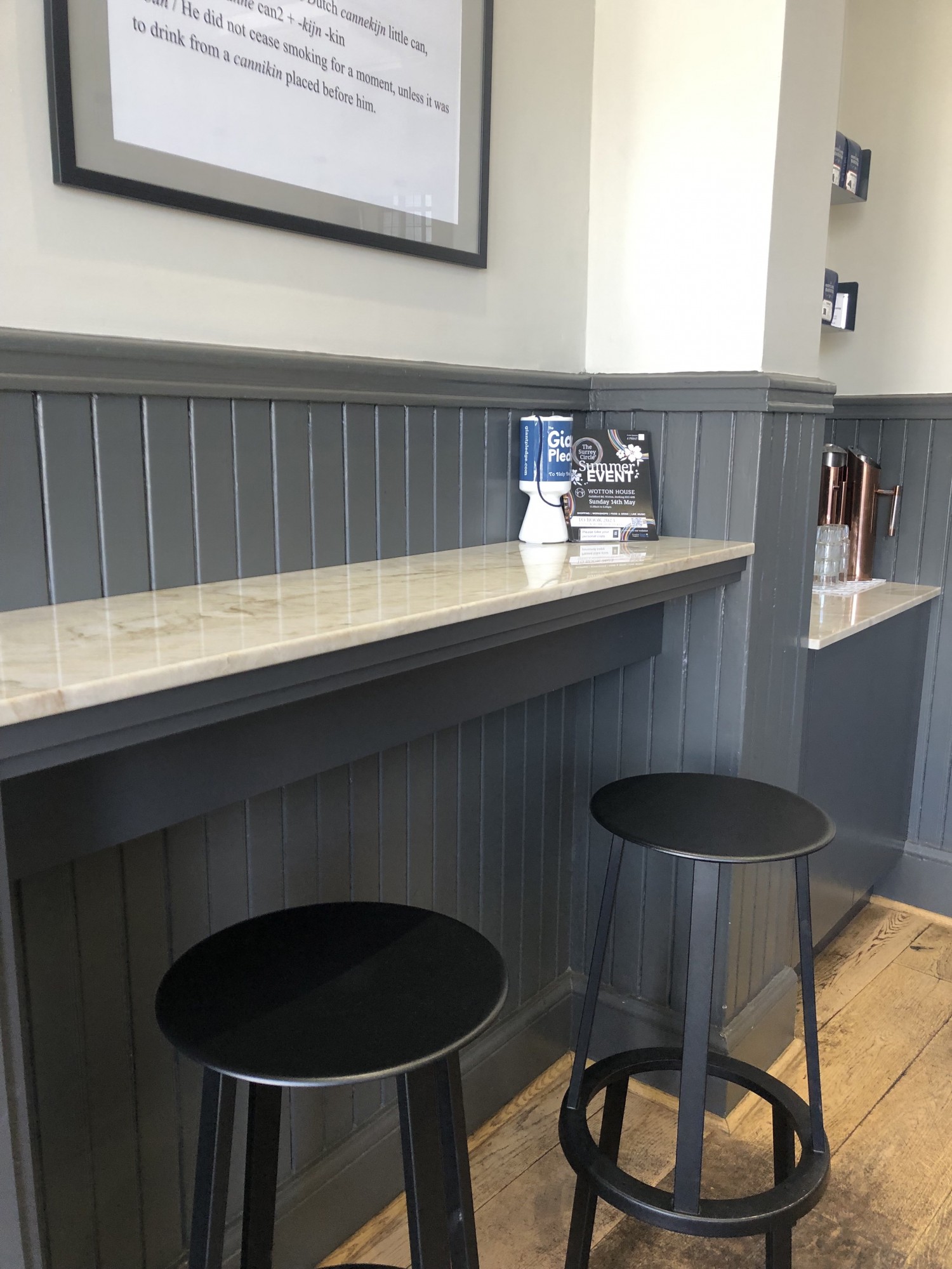 Marble high counter table with two barstools which can swivel.