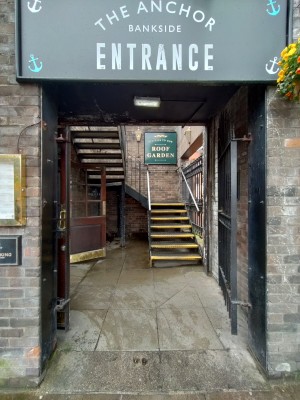 Main entrance. Right side of venue. Open doorway.