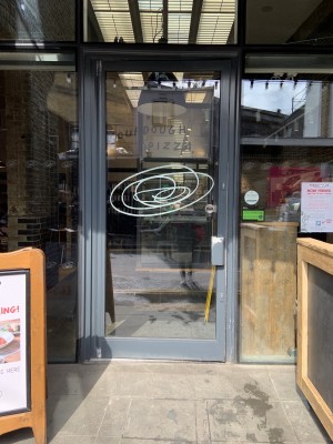 Entrance in centre of the venue, pulls to open by small handle on right side of door.