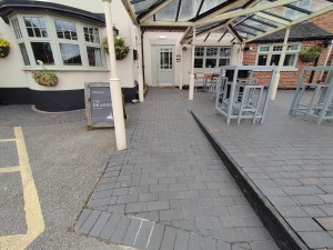 Main entrance. Long built in ramp to access the venue. Colums on both sides supporting the roof.