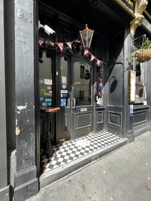 Single black wooden door with window. Pull silver metal handle from left to open.
