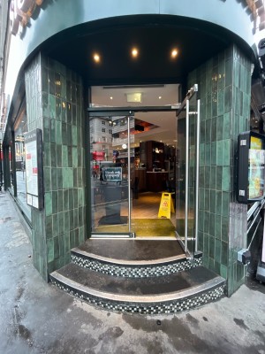 Double glass doors. Pull silver vertical metal handle from centre to open.